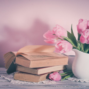 Poem still life with books and pink tulips